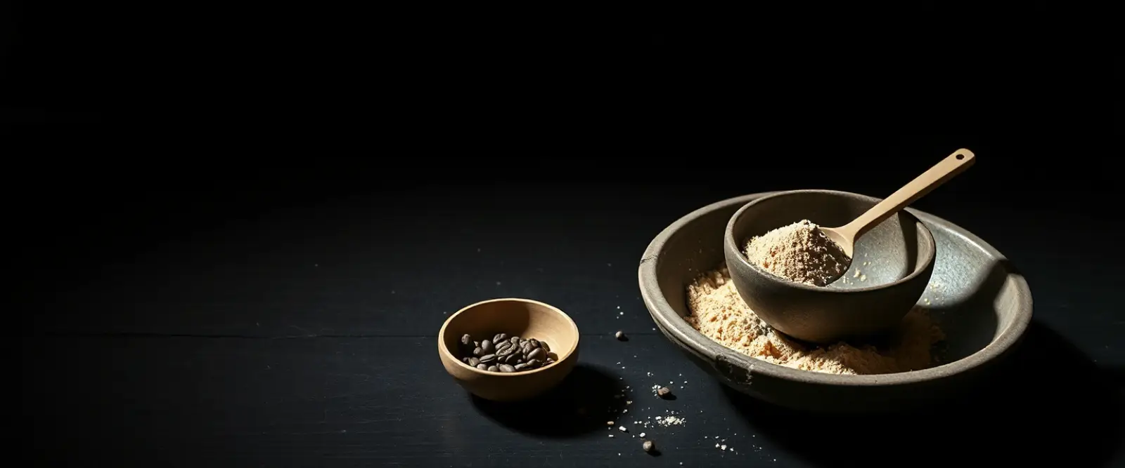 A wide stone bowl of fine tea powder with a bamboo whisk lying beside it.